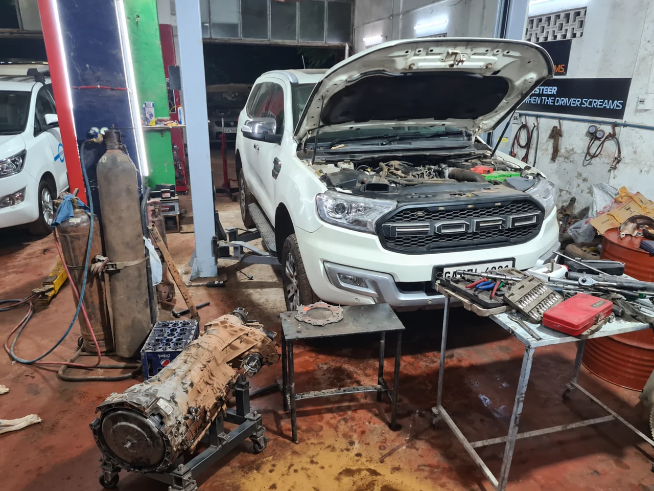 Ford Endeavour with its gearbox removed and supported on a workshop stand